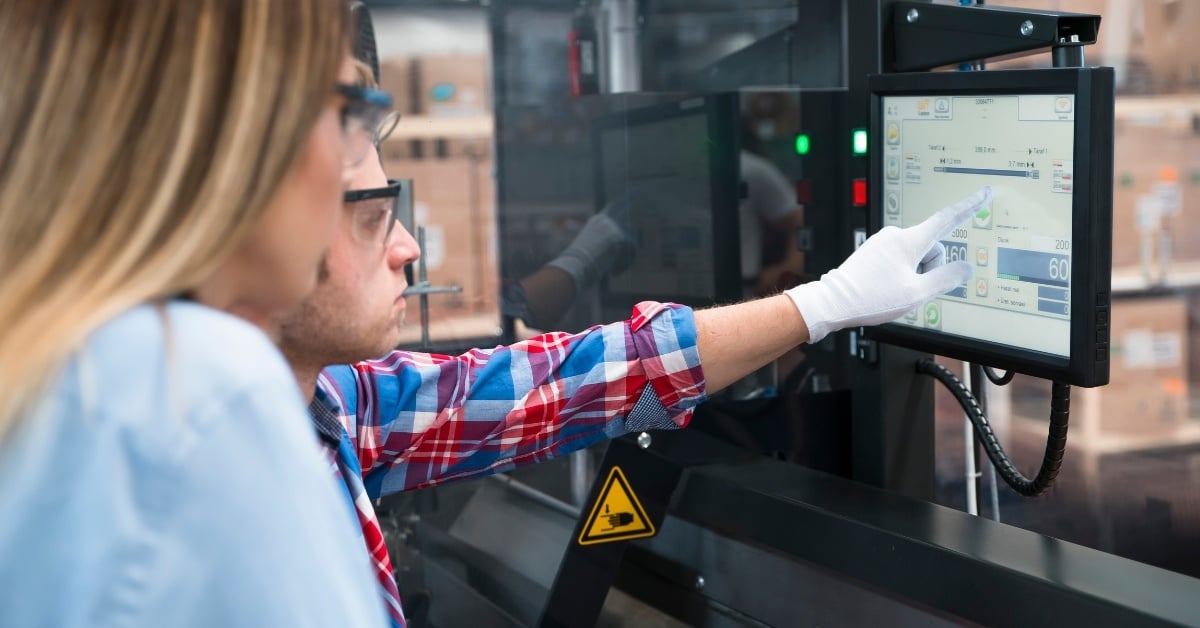 Employees Operating Manufacturing Technology in a Warehouse